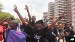 Supporters of Nigeria's President Bola Tinubu celebrate on Oct. 26, 2023, after the Supreme Court in Abuja refused to void his recent election.