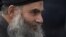 Abu Qatada arrives back at his residence in London after being freed from prison, November 13, 2012. 
