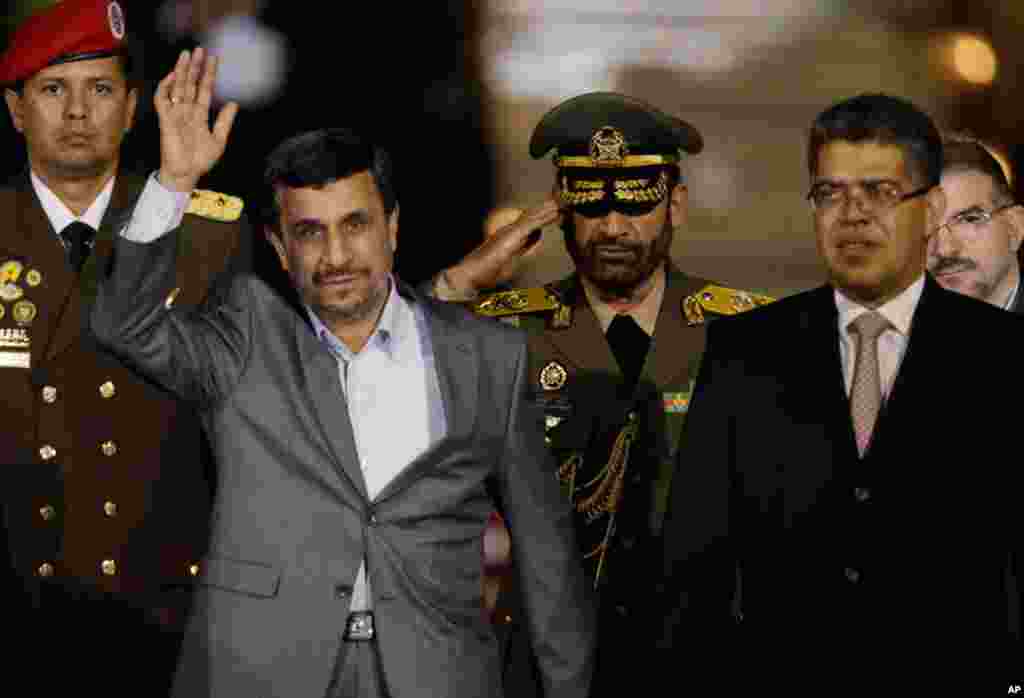 Iran's President Mahmoud Ahmadinejad waves upon his arrival at the international airport in Maiquetia, Venezuela, on January 8, 2012, at the start of his Latin American tour.  (AP)