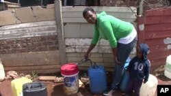 Emily Ntake pumps water in South Africa's Makause community