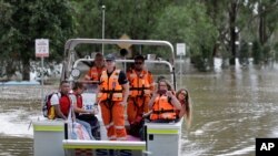 People prepared to disembark after rescuers ferried them across the flooded Hawkesbury River in Windsor, New South Wales, northwest of Sydney on March 25, 2021.