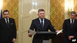 Slovak Prime Minister Robert Fico, center, Slovak National Party chairman Andrej Danko, left, and Most-Hid Chairman Bela Bugar attend a press conference after a coalition council in Bratislava, Slovakia, March 14, 2018. 