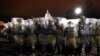 FILE - Members of the District of Columbia National Guard stand outside the Capitol after a day of rioting protesters, Jan. 6, 2021. A report released March 17, 2021, warns that the U.S. is facing one of its most lethal terror threats from within.