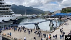 Passengers coming from a cruise ship that docked on June 12, 2023, in downtown Juneau, Alaska. As the Mendenhall Glacier continues to recede, tourists are flooding into Juneau. A record number of cruise ship passengers are expected this year in the city of about 30,000 people. (AP Photo/Becky Bohrer)