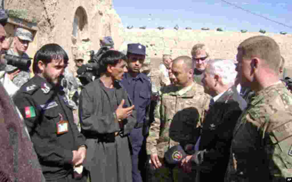 Secretary Gates receives a briefing from village elders and local policemen in Tabin