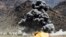 FILE - An explosion is seen after airstrikes during fighting with insurgents in Afghanistan.