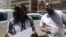 Sheffra Dzamara and a member of the Zimbabwe Lawyers for Human Rights outside President Emmerson Mnangagwa's office in Harare. (Photo: Mlondolozi Ndlovu)