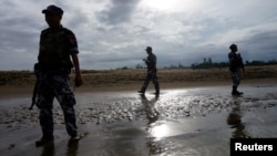 FILE : A Myanmar border guard police officers stand guard in Buthidaung, northern Rakhine state, Myanmar July 13, 2017.