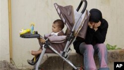 Syrian refugee with her baby near the border town of Wadi Khaled, Lebanon, May 2012.