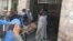 Injured man exits attack area on a stretcher after suicide bombers attacked a court in Charsadda, Pakistan, Feb. 21, 2017. (Photo: A. Momand / VOA Deewa Service)