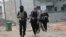 Gunmen patrol during clashes with Iraqi security forces in Fallujah, 40 miles (65 kilometers) west of Baghdad, Iraq, Jan. 5, 2014. 