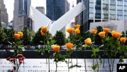 Flowers are placed in the inscribed names of the deceased at the 9/11 Memorial & Museum in New York, Sept. 11, 2020.