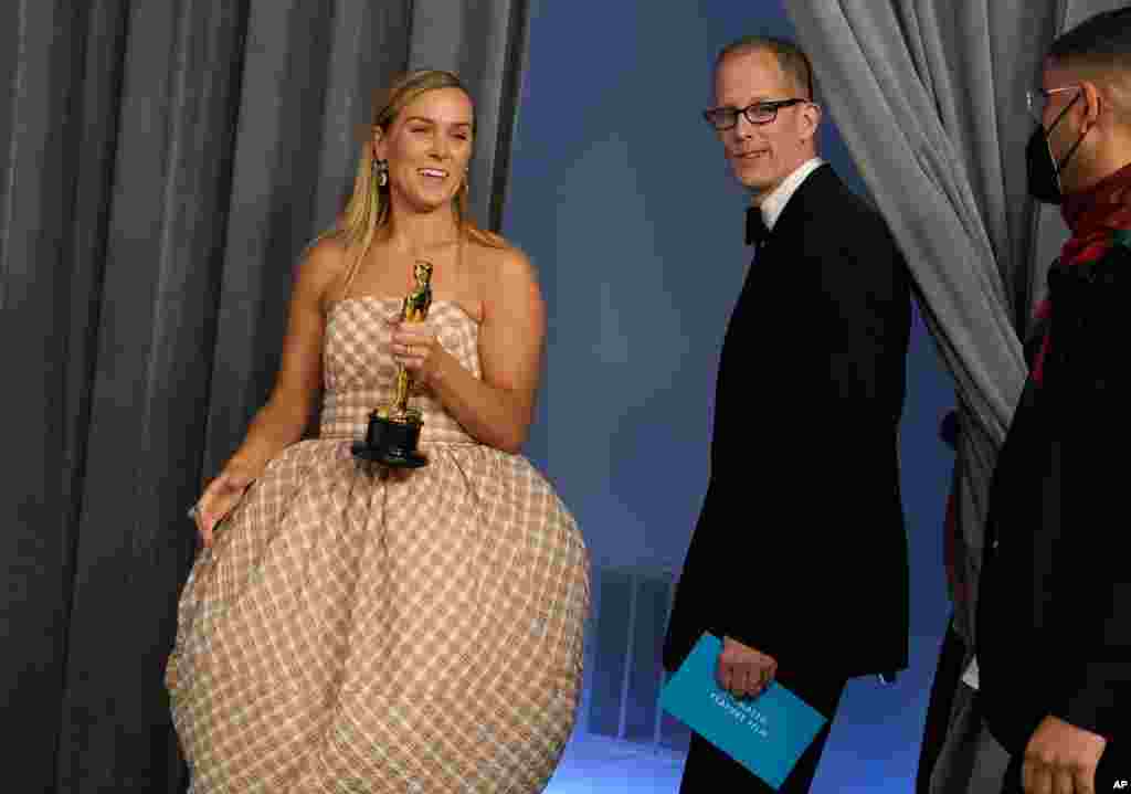 Dana Murray, left, and Pete Docter, winners of the award for animated feature film for &quot;Soul,&quot; enter in the press room at the Oscars on Sunday, April 25, 2021, at Union Station in Los Angeles. (AP Photo/Chris Pizzello, Pool)