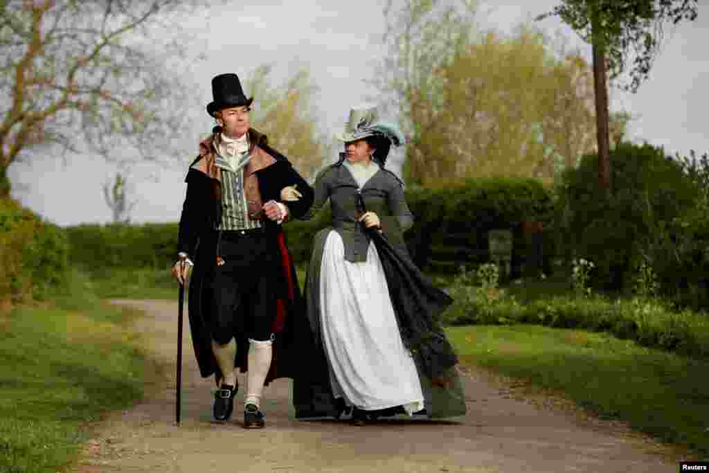 Izabela Pitcher, owner of Prior Attire, and her husband Lucas dressed in historical attire, take their daily evening walk around their Buckinghamshire village near Milton Keynes, Britain, April 13, 2020.