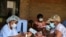 FILE - A man receives a certificate after being vaccinated against the coronavirus disease (COVID-19) at Wilkins Hospital in Harare, Zimbabwe, March 24, 2021.
