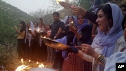 The midnight sun casts a golden glow on an iceberg and its reflection in Disko Bay, Greenland. Much of Greenland’s annual mass loss occurs through calving of icebergs such as this. (Photo courtesy Ian Joughin)