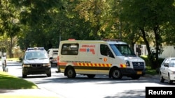 An ambulance believed to be transporting former South African president Nelson Mandela arrives at his house in Houghton, April 6, 2013. 