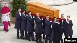 The coffin of former Pope Benedict is carried during his funeral, in St. Peter's Square at the Vatican, Jan. 5, 2023. 