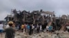 This photo taken and obtained from the Facebook account of Mai So Jar on Sept. 6, 2024 shows people gathering around a destroyed building following an air strike in Namhkham township in Myanmar's northern Shan state. (Photo Courtesy of Facebook user Mai So Jar / AFP) 