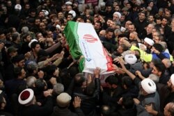 Iranian people carry a coffin of Iranian Major-General Qassem Soleimani, head of the elite Quds Force, who was killed in an airstrike at Baghdad airport, during a funeral procession in Tehran, Iran, Jan. 6, 2020.