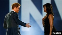 Britain's Prince Harry (L) and U.S. First Lady Michelle Obama take part in the opening ceremonies of the Invictus Games in Orlando, Florida, U.S., May 8, 2016.