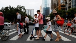 FILE - Children and their parents are seen on their way to the school in Tianhe district in Guanghzou, China, September 4, 2019. (REUTERS/Jorge Silva/File Photo)