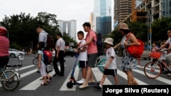 FILE - Children and their parents are seen on their way to the school in Tianhe district in Guanghzou, China, September 4, 2019. (REUTERS/Jorge Silva/File Photo)