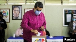 FILE - Venezuela's President Nicolas Maduro votes at a polling station during the parliamentary election in Caracas, Venezuela, Dec. 6, 2020.
