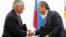 FILE - Igor Sechin, CEO of state-controlled Russian oil company Rosneft, right, and Exxon Mobil Corp. CEO Rex Tillerson shake hands after signing an agreement at the Black Sea port of Tuapse, southern Russia, June 15, 2012. 