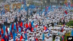 Supporters of Cambodian People's Party gather for their last campaign for the July 29 general election, in Phnom Penh, Cambodia, Friday, July 27, 2018. Political exiles and Western governments are raising concerns about whether Cambodia's elections this weekend will be free and fair. Prime Minister Hun Sen's ruling party has banned the main opposition party, jailed its leaders and other critics and shut independent media outlets. Opposition politicians in exile in the United States, Australia and elsewhere are using social media to urge voters to embrace a "clean finger campaign" and boycott the vote. (AP Photo/Heng Sinith)