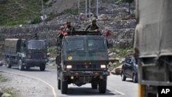 An Indian army convoy moves on the Srinagar- Ladakh highway at Gagangeer, north-east of Srinagar, India, Wednesday, June 17, 2020. 