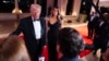 Melania Trump looks on as U.S. President-elect Donald Trump speaks to reporters before a New Year's Eve party at Mar-a-Lago on Dec. 31, 2024, in Palm Beach, Florida. Trump told reporters he plans to attend the funeral of former President Jimmy Carter.