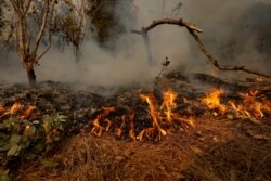 FILE - Flames and smoke from the Bobcat Fire are pictured after an evacuation was ordered for the residents of Arcadia, Calif., Sept. 13, 2020.