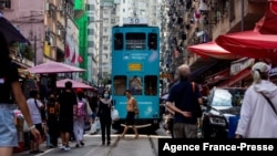 A tram makes its way through a street market in the North Point district of Hong Kong on Nov. 5, 2021.