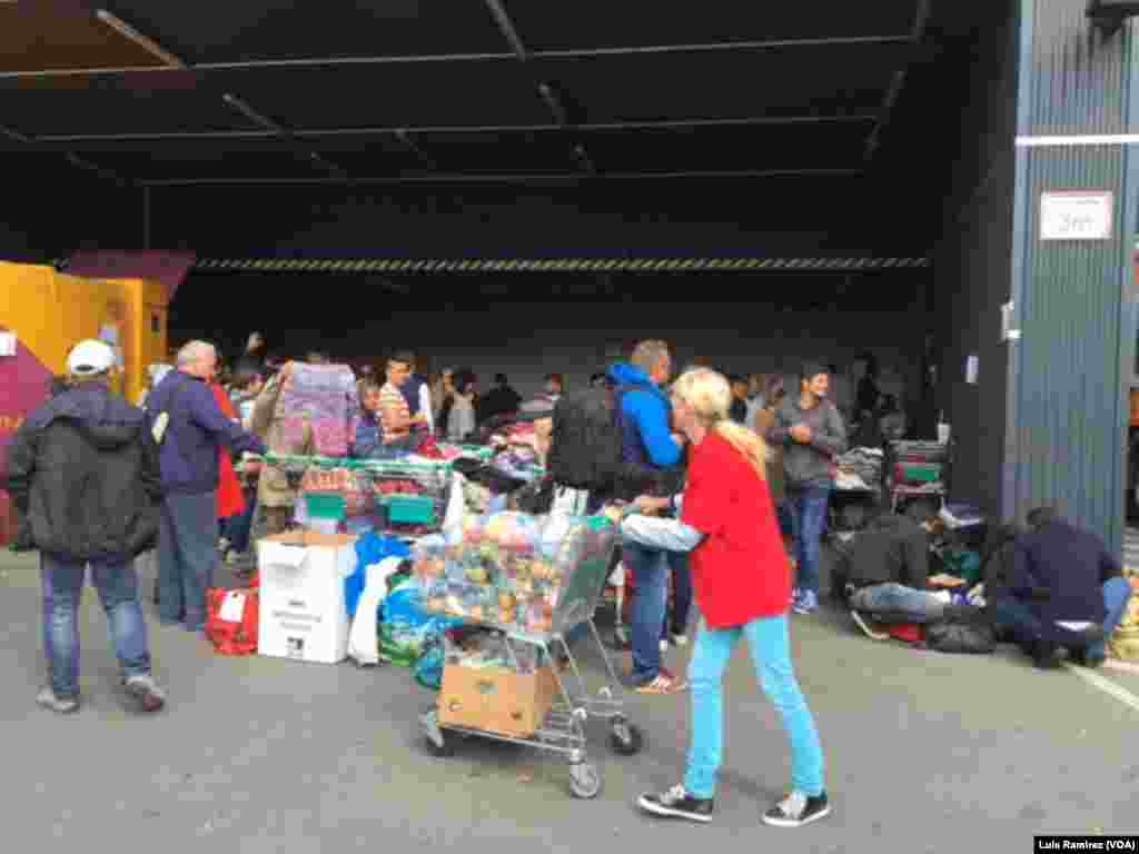 Pekerja sukarela membagikan makanan untuk para pengungsi yang tiba di Wina, Austria (6/9).