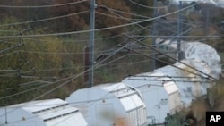 The train carrying 11 containers of nuclear waste, called CASTORs, leaves Valognes, northwestern France, Wednesday Nov. 23, 2011.