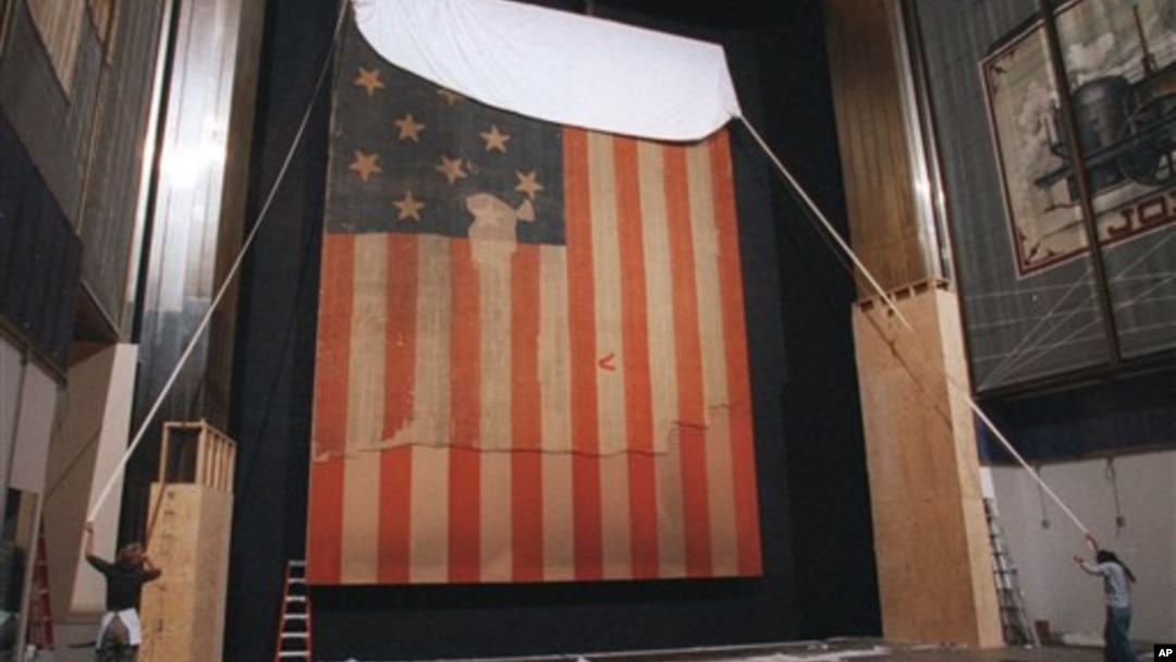In this Nov. 20, 1998 file photo, workers at the Smithsonian's National Museum of American History cover the flag that inspired "The Star Spangled Banner," prior to the flag's restoration.