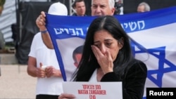 A person reacts as family members and supporters of hostages deliver statements for the release of hostages who were kidnapped during the deadly October 7, 2023 attack by Hamas, n Tel Aviv, Jan. 17, 2025.