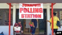 这张拍摄于2024年1月25日的照片显示，选举当天，南太平洋国家图瓦卢首都富纳富提的一个投票站外，人们站着或坐着。