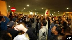 People gather to mourn and protest for demonstrators who were injured after riot police stormed an anti-government protest camp in Manama, February 17, 2011