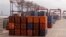 FILE - Goods are stacked in containers destined for global distribution at the harbor in Cape Town, South Africa, June 24, 2016. 