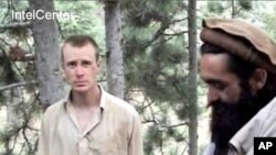 IntelCenter shows the Taliban video production of someone who appears to be US soldier Bowe Bergdahl (L). Also with him in this clip appears to be Taliban commander Maulawi Sangin (R), 7 Dec 2010