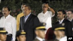 Nicaragua’s President Daniel Ortega, left, Venezuela's President Hugo Chavez, second left, Iranian President Mahmoud Ahmadinejad, second right, and Akbar Esmaeil Pour, Iran's ambassador to Nicaragua, right, stand during an honor guard presentation at Orte