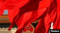 The Great Hall of the People, where the Chinese Communist Party plenum is being held, is seen behinds red flags in Tiananmen square in Beijing November 12, 2013. China's leaders will unveil a reform agenda for the next decade on Tuesday, seeking to balan