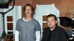 FILE - Brad Pitt, left, and Leonardo DiCaprio at the photo call for "Once Upon a Time in Hollywood" in Los Angeles, July 11, 2019. 