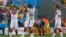 German soccer players celebrate win as France's Antoine Griezmann reacts after the final whistle is blown at 2014 World Cup quarter-finals, Maracana stadium, Rio de Janeiro, July 4, 2014.
