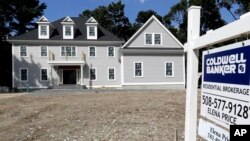 In this Sept. 3, 2019, photo a sign rests in front of a newly constructed home, in Westwood, Mass. America's new homes are much larger than they used to be. (AP Photo/Steven Senne)