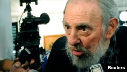 Former Cuban leader Fidel Castro speaks to reporters at a polling station in Havana, February 3, 2013. 