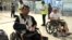 Cambodian opposition​ CNRP lawmakers Nhay Chamroeun (left) and Kong Saphea (right) are seen arriving in wheelchairs at Bangkok airport on Tuesday, October 27, 2015 after being beaten by protesters in Phnom Penh, Cambodia on Monday. (Courtesy of Nhay Chamroeun)