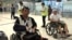 Cambodian opposition​ CNRP lawmakers Nhay Chamroeun (left) and Kong Saphea (right) are seen arriving in wheelchairs at Bangkok airport on Tuesday, October 27, 2015 after being beaten by protesters in Phnom Penh, Cambodia. (Courtesy of Nhay Chamroeun)